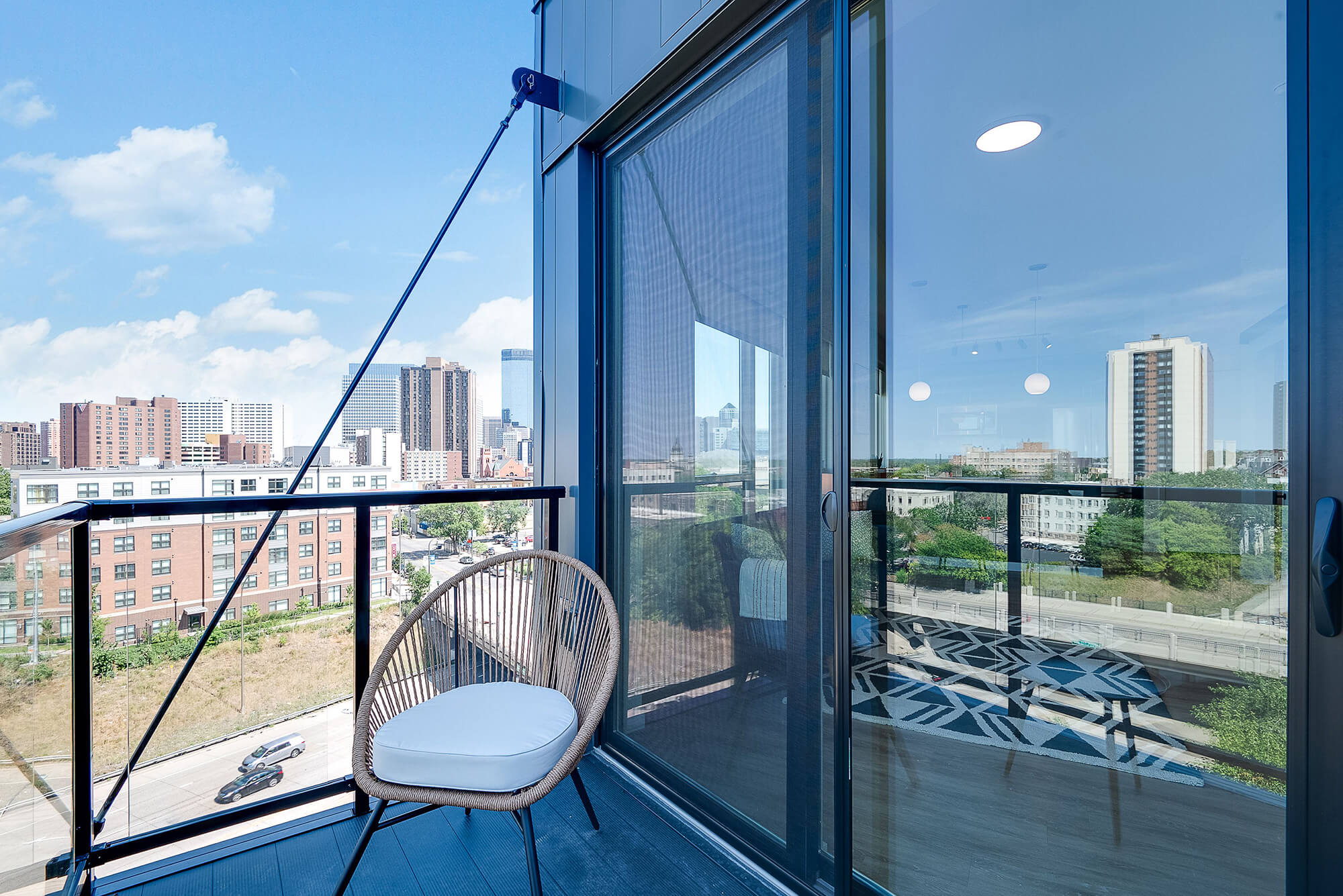 an apartment balcony with a view of the downtown minneapolis skyline
